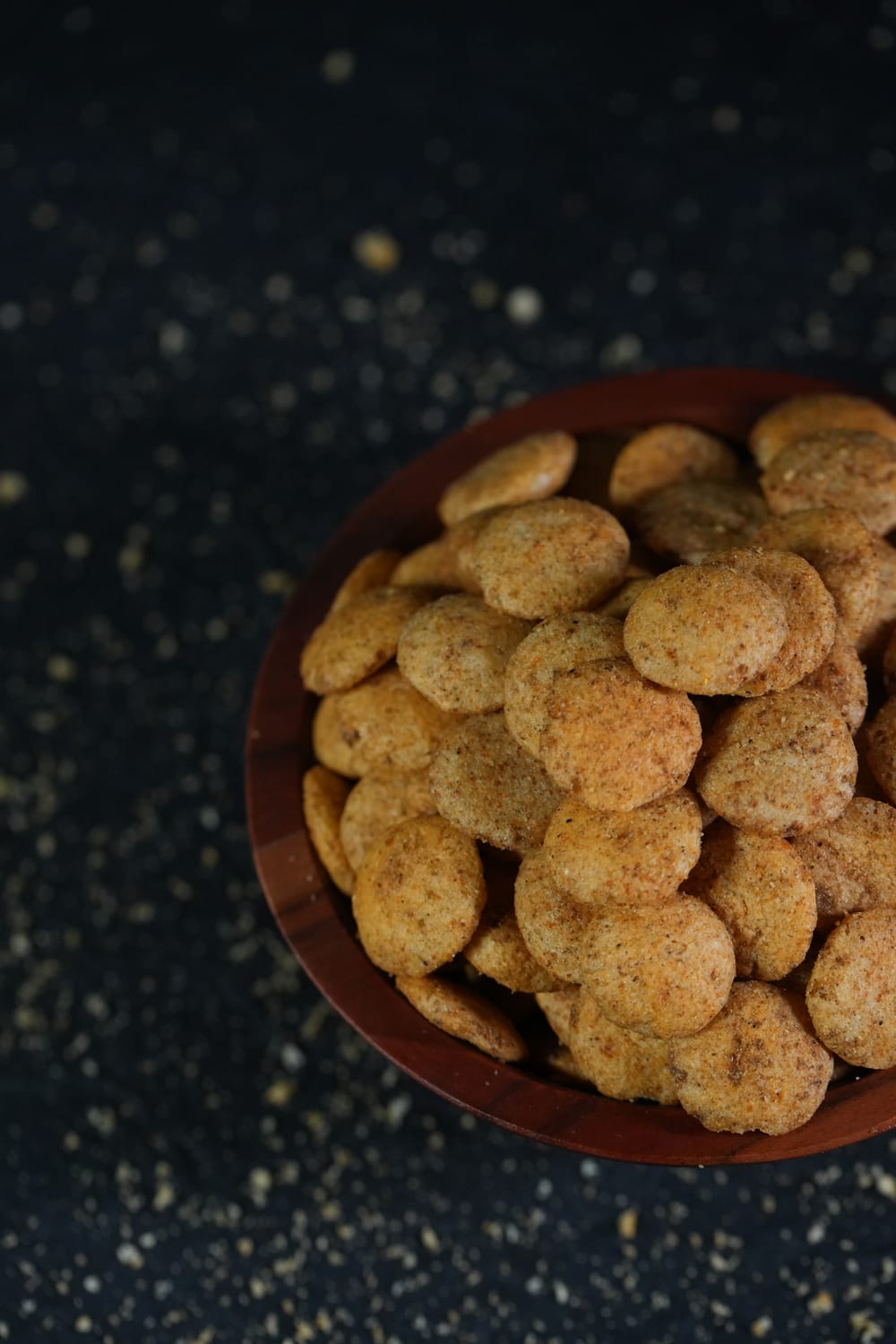 A wooden bowl piled with DrinksBite jowar puffs